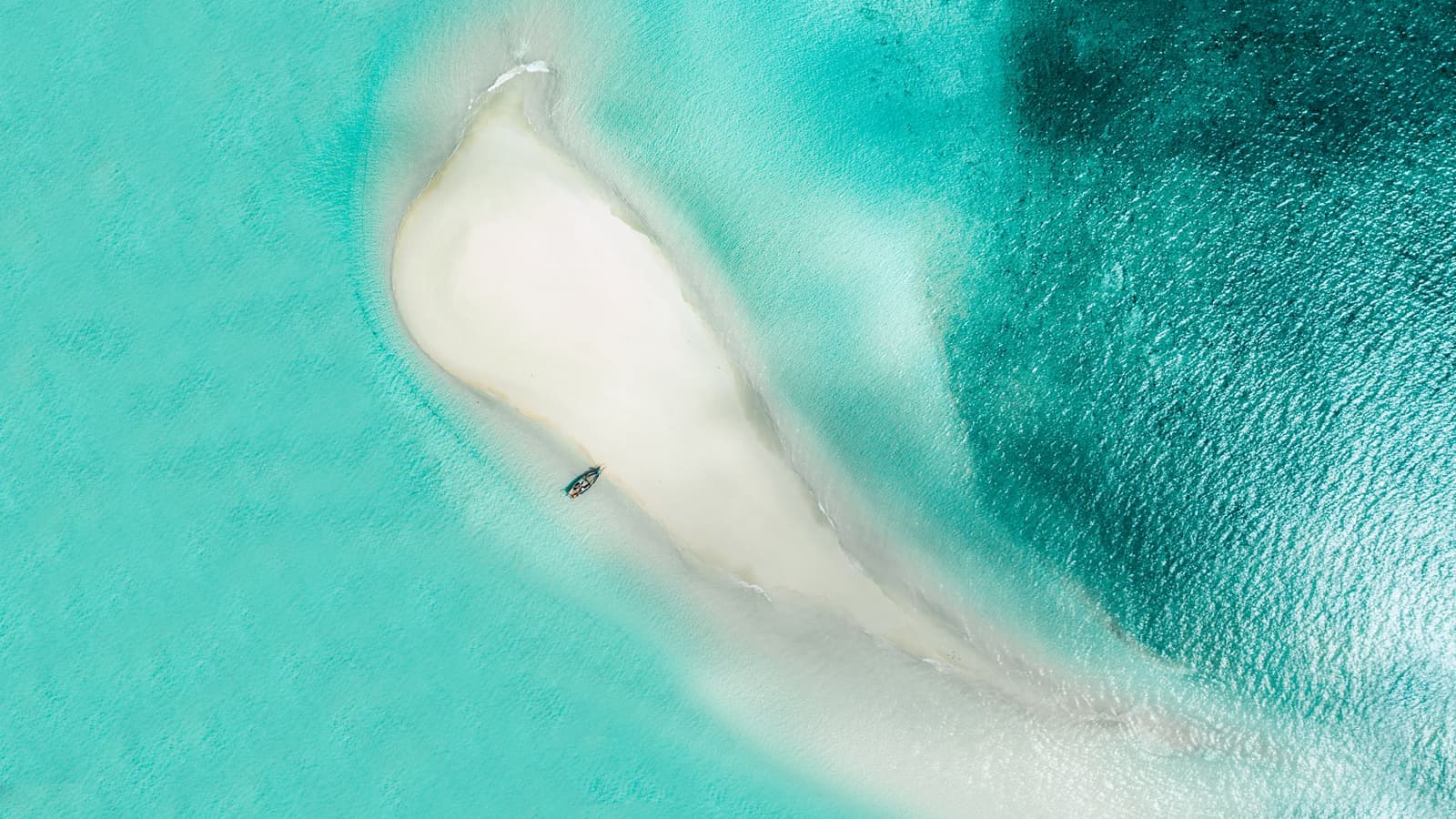 Aerial view of a white sandbank surrounded by turquoise water