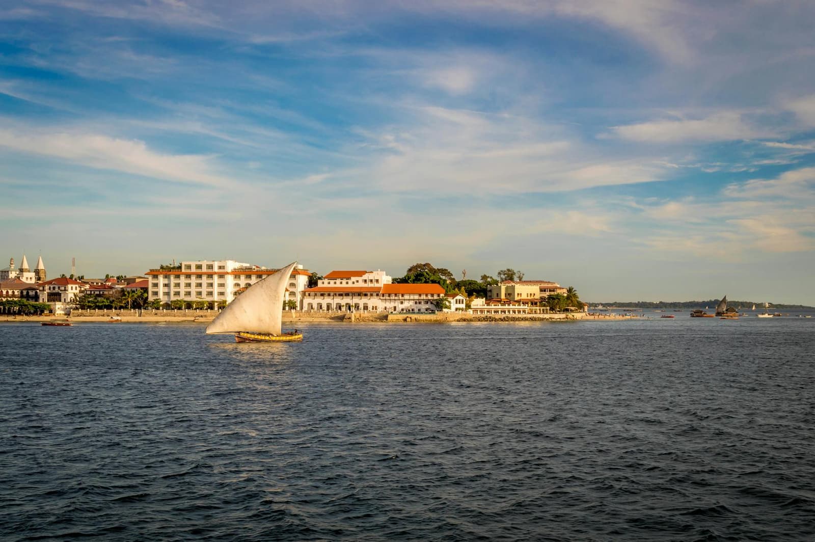 Traditional dhow sailing past the Stone Town seafront